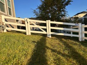 A white vinyl ranch-style fence with integrated wire mesh and a matching gate, installed by AFK FENCE LLC in Waldorf, MD.