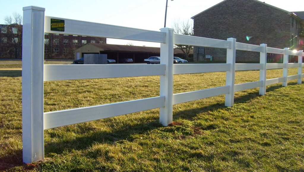 A white vinyl ranch-style fence installed in a grassy field by Raatz Fence Company in Louisville, KY.