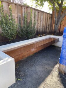 A white wood fence with a lattice top and an arched gate by Jaz Builders Inc in Santa Clara, CA.