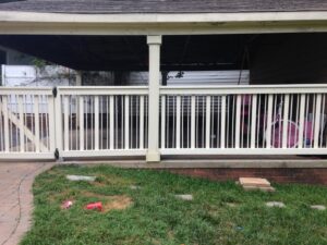 A white wooden railing and gate enclosing an area under a carport, installed by Timber Fencing in Charlotte, NC.