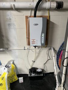 A wall-mounted whole-home humidifier system with a drainage pump, installed by Prime Home HVAC for improved indoor air quality in York, PA.