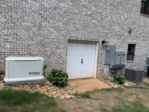 A Generac whole-house generator installed next to an electrical panel by Hilman Electric LLC in Greenville, SC.