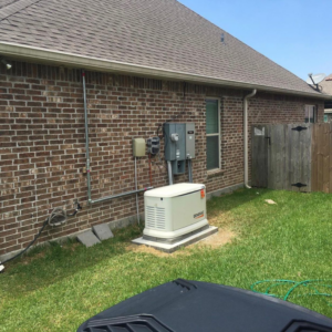 A Generac whole-house generator installed outside a brick home by Immaculate Electric in Lake Charles, LA.