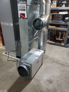 A whole-house humidifier installation connected to a furnace by AccuMax Incorporated in Aurora, IL.