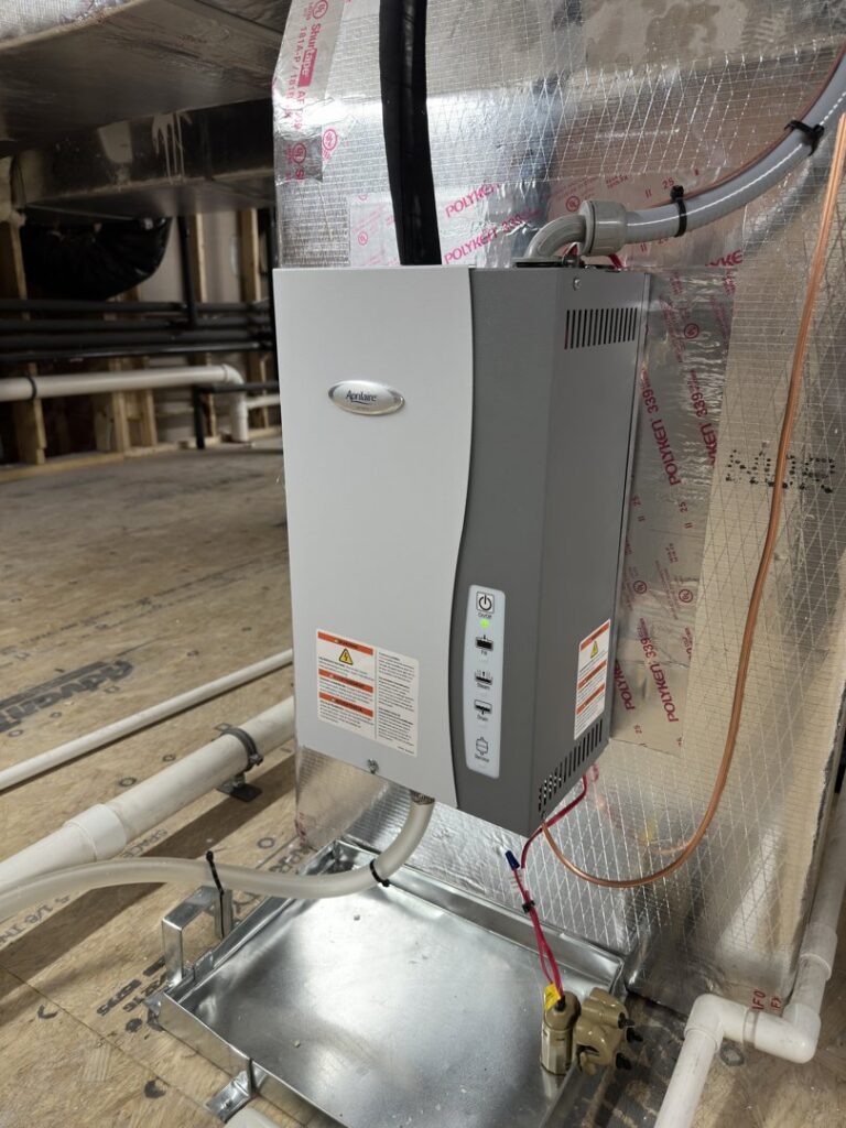A whole-house humidifier or air purification unit installed on ductwork by Chad Byers - Edge Guys Heating & Cooling in Carmel, IN.