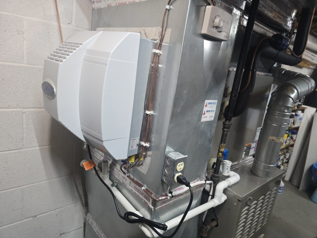 A whole-house humidifier unit installed on a furnace by Comfort-Tech llc, an HVAC contractor in Alexandria, VA.