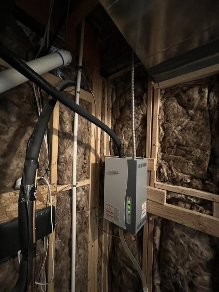 A whole-house humidifier or HVAC accessory installed in a utility space by TriForce HVAC in Layton, UT