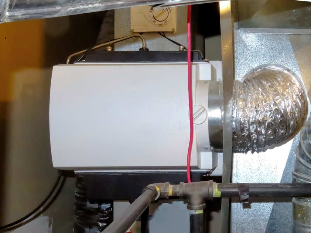 A whole-house humidifier unit connected to ductwork, installed by Comfy Cave Heating and Air Conditioning in Arvada, CO.