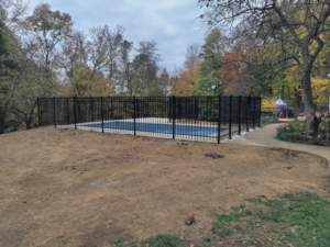Wide view of a completed black aluminum pool fence installation by Wallace Fencing in Cincinnati, OH.