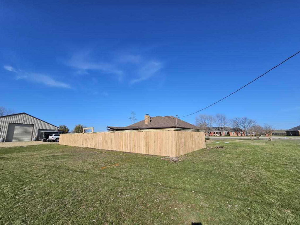 A wide view of a newly installed wood privacy fence by Straight Shot Solutions, LLC in Fort Worth, TX.