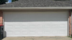 A wide white panel garage door on a brick house, installed by Legacy Garage Doors & Repairs in Church Point, LA.