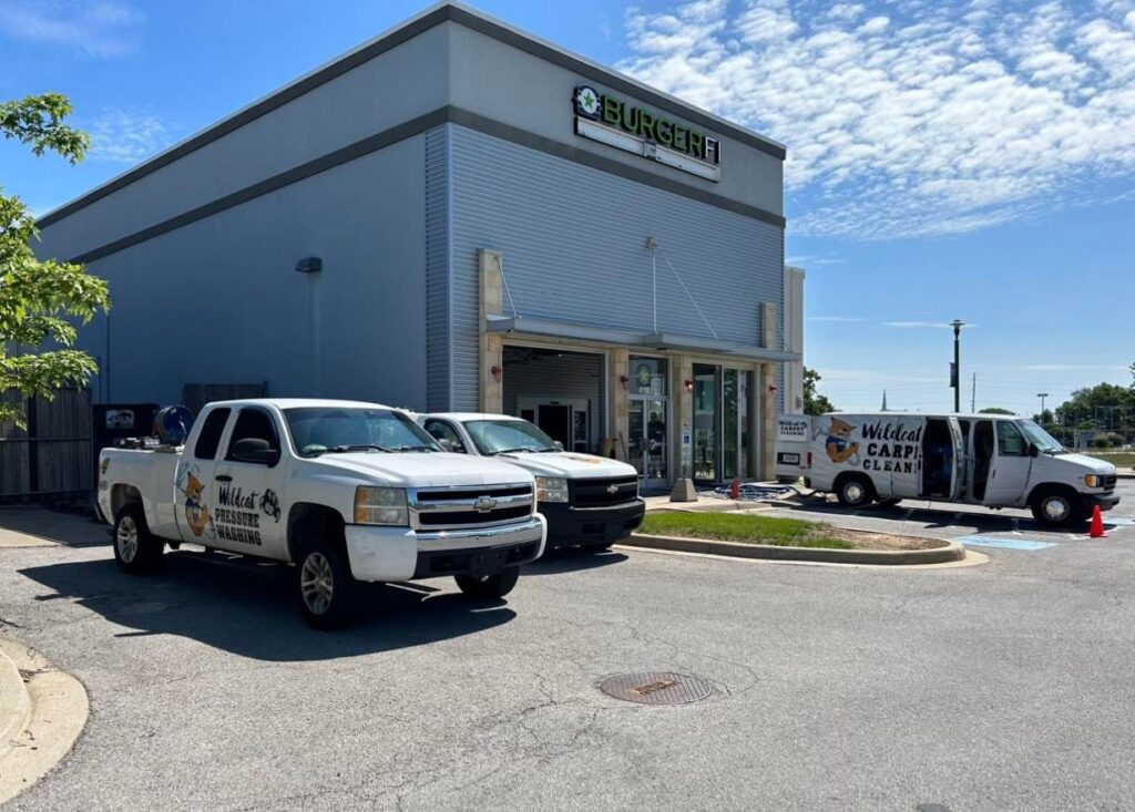 Wildcat Carpet Cleaning vans and trucks parked at a commercial job site in Nicholasville, KY.