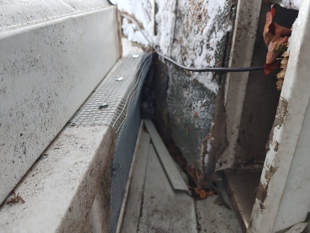 Installation of a wire mesh barrier for wildlife prevention around a structure by Pest Express LLC in Rochester, NY