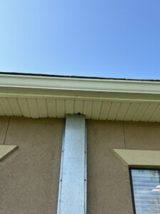 A metal barrier installed on a building for wildlife exclusion by Crawford Pest Control in Jacksonville, FL.