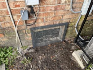 A metal mesh installed over a crawl space opening for wildlife exclusion by Crawford Pest Control in Jacksonville, FL.