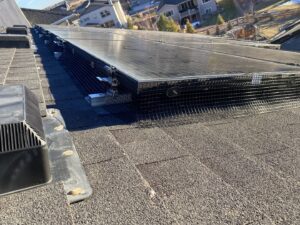 Wildlife exclusion mesh installed around solar panels on a roof by No Moore Pests in Pueblo, CO, preventing pest entry.