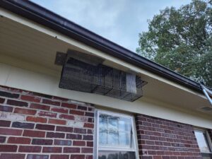 A wildlife exclusion device with a trap installed under the eaves of a house by S-Tier Wildlife Control LLC in Lexington, KY.