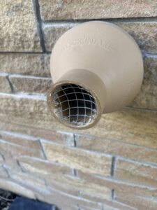 A vent cover with a wire mesh screen, an exclusion device installed to prevent wildlife entry by Critter Control of Omaha, NE