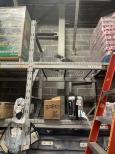 A wildlife or rodent trap placed on a high shelf in a warehouse, set by JPC Exterminating, LLC in New Orleans, LA.