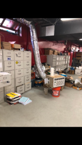 A window AC unit connected to flexible ductwork in a commercial space, handled by Iconic HVAC Solutions in Philadelphia, PA.