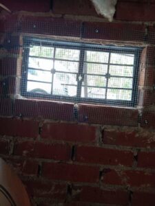 A window opening covered with a protective mesh screen for wildlife exclusion and pest proofing by A Better Way Pest Solutions LLC in Rock Hill, SC