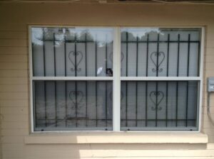 Window security bars with heart-shaped decorative design installed by Ability Burglar Bars in Jacksonville, FL.