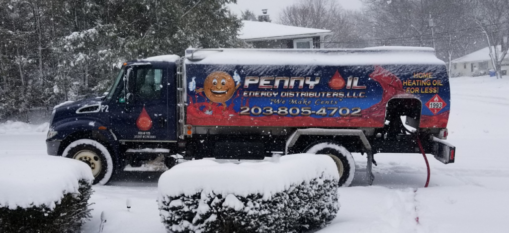 A Penny Oil Energy Distributors LLC truck making a heating oil delivery in the snow in Waterbury, CT.