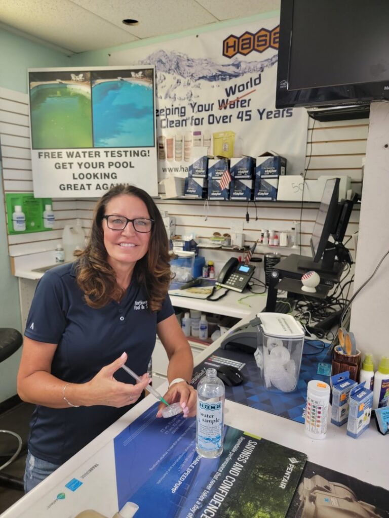 A woman performing professional pool water testing at Northwest Pool and Spa Dunlap in Phoenix, AZ.
