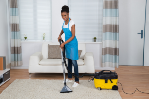 A woman performing professional carpet cleaning with an extractor at Spears Americare in Hopkinsville, KY.