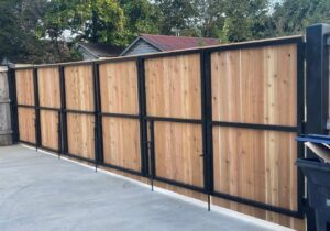 A custom wood and black metal combination fence and gate installed by Master Fences in Gaithersburg, MD.