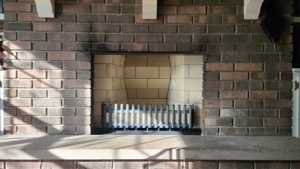 A cozy wood-burning stove with a fire glowing, connected to a chimney system by Chimney Mechanix of Indiana in Lafayette, IN.