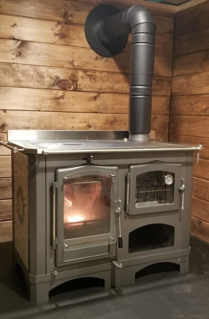 A wood cookstove with a burning fire, expertly installed by Wood Stoves For Sale in Fairbanks, AK.