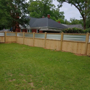 A wood and corrugated metal privacy fence enclosing a backyard by Fence & Custom Gatework LLC in Columbia, SC