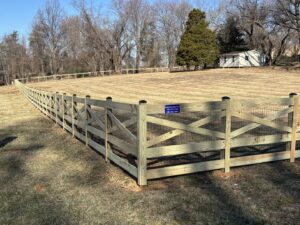A long wooden cross-buck fence with wire mesh installed by Universal Fence LLC in Drainesville, VA.