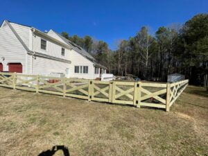 A sturdy wood crossbuck fence with wire mesh and double gates, installed by Superior Fence & Rail Richmond, VA.