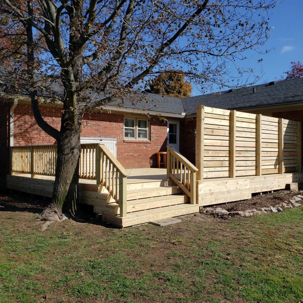 A newly built wooden deck featuring a privacy screen by Veteran Fence in North Royalton, OH.