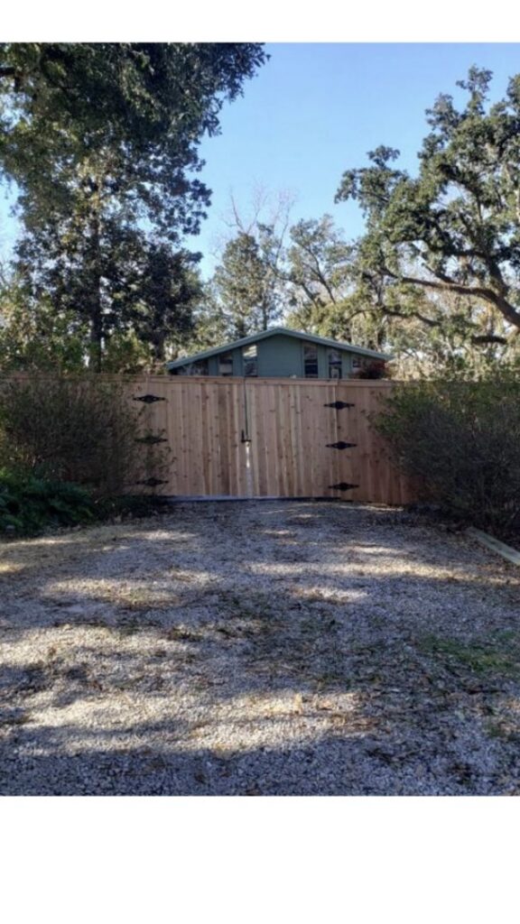 A wood double gate installed at a driveway entrance by A-1 Security Fence in Scott, LA.