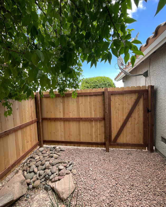 A new wood fence and gate installation in a residential area by 702 Fence LLC in Las Vegas, NV.