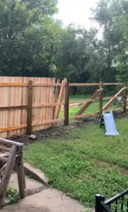 A wooden fence installation in progress, showing posts and panels being set by Discount Fence Supply in Great Falls, SC.
