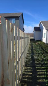A wood fence construction in progress with posts and string lines by Fencing Company Of Omaha in Omaha, NE.
