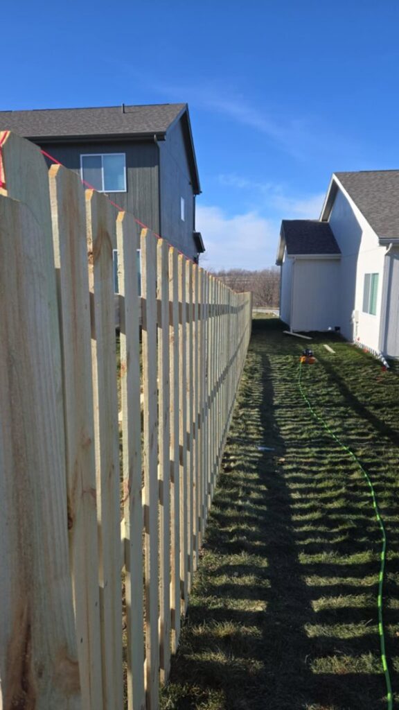 A wood fence construction in progress with posts and string lines by Fencing Company Of Omaha in Omaha, NE.