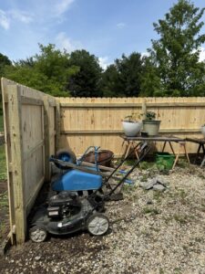 A newly installed wood fence corner in a backyard gardening area, completed by ReliableFencing in Columbus, OH.