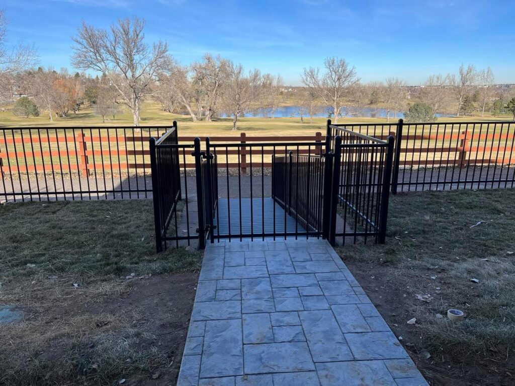 A wooden fence frame with metal posts under construction in a backyard by Supreme Fencing Denver, CO.