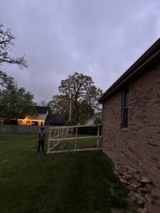 The wooden framing of a fence under construction, showing horizontal rails, by Axiom Fence LLC in Springfield, MO.