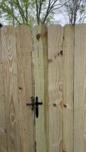 A close-up view of a new wood fence gate with decorative black hardware, installed by ReliableFencing in Columbus, OH.