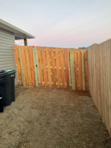 A newly installed wood fence gate in a residential side yard by Best Fences LLC in Springdale, AR.