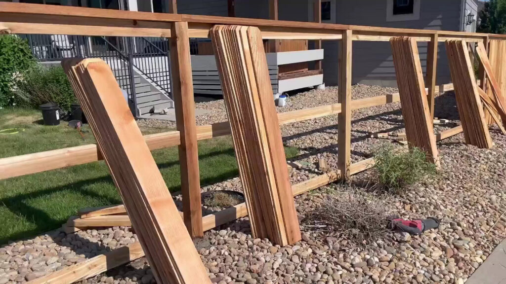 A wood fence installation in progress with pickets ready to be attached by Supreme Fencing Denver, CO.