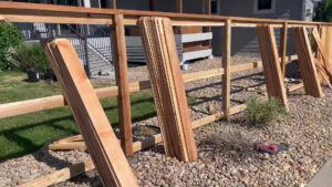 A wood fence installation in progress with pickets ready to be attached by Supreme Fencing Denver, CO.