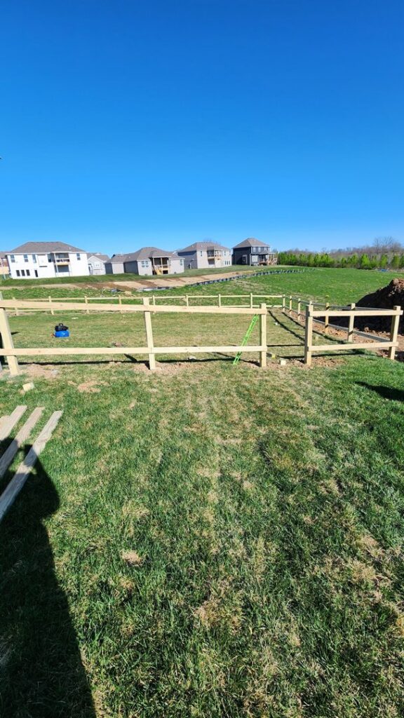 Wood fence posts and rails installed, showing a fence in progress by Hotshot Fencing and Gates in Kansas City, MO.