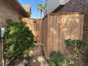 A new wood fence with a gate providing secure side access, installed by Wood Fence Houston in Houston, TX.